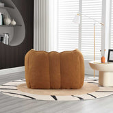 Brown pouf on a round rug in a modern living room with blinds and decor.
