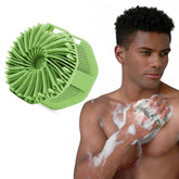 Man using a green scrubber on his skin with a close-up of the scrubber on a white background.