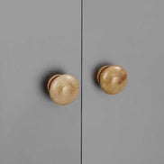 Detail view of the wooden knobs on the gray cabinet doors of the multi-functional shoe storage bench, showing craftsmanship.