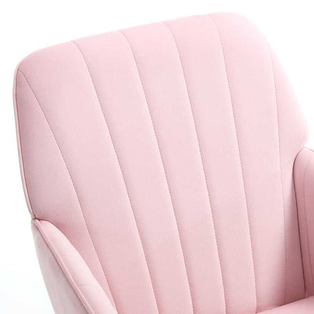 Close-up of a pink upholstered chair with a quilted pattern.