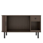 Cat litter box enclosure with storage drawer and charging station in modern brown wood finish. Features sliding door and elevated legs for easy cleaning.