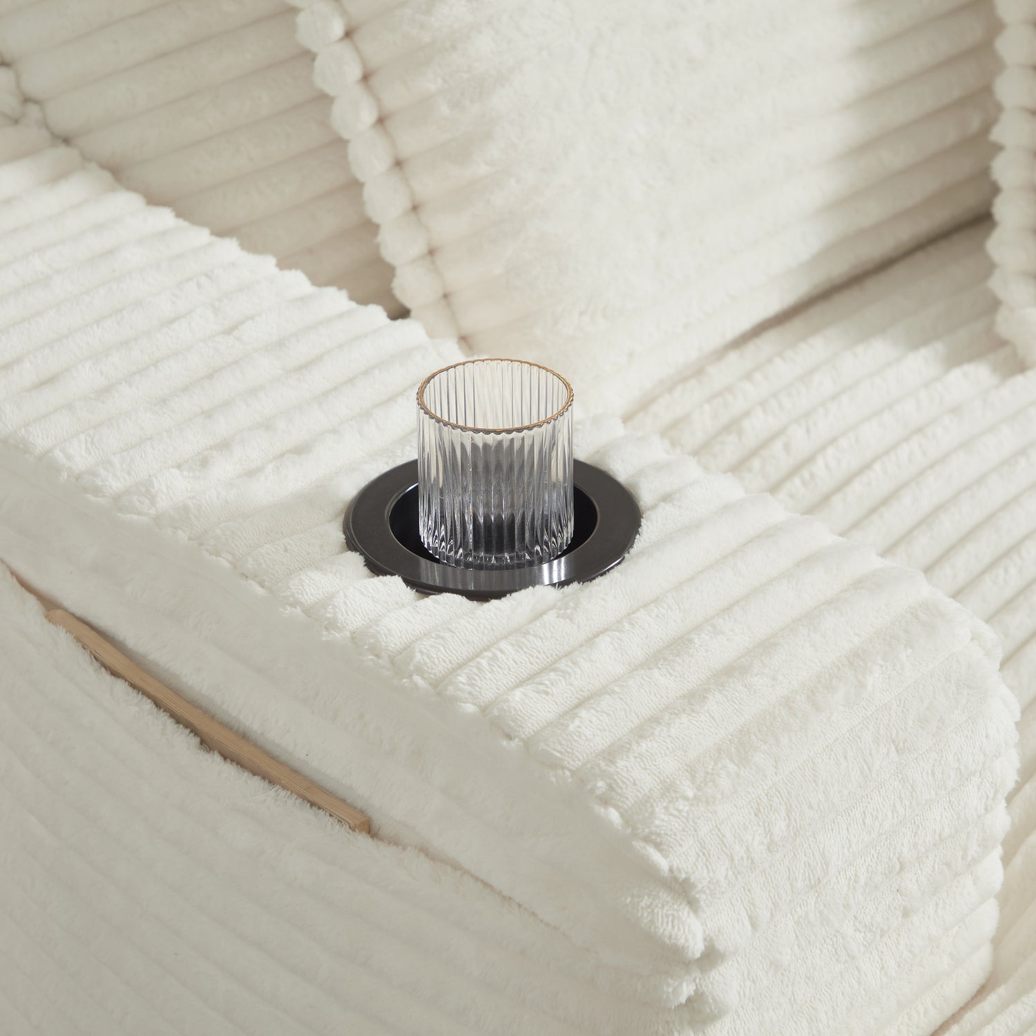 Glass candle holder on a textured white surface