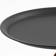 Detail view of the black round tabletop of the Modern Metal Mermaid Tail Coffee Table. Smooth metal surface ideal for accent use.