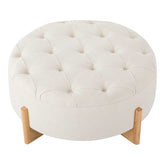 Round ottoman with tufted white cushion and wooden legs on a white background