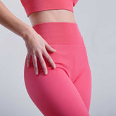 Close-up of hand on hip in pink Seamless Tummy Control Yoga Pants, showing high waist and supportive fit for activewear use.