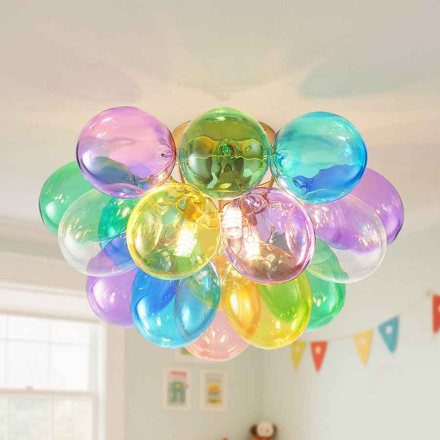 Colorful balloon chandelier hanging in a room with a light background