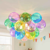 Colorful balloon chandelier hanging in a room with a light background