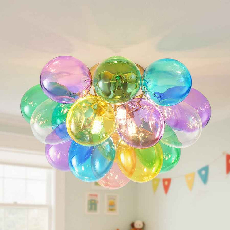Colorful balloon chandelier hanging in a room with a light background