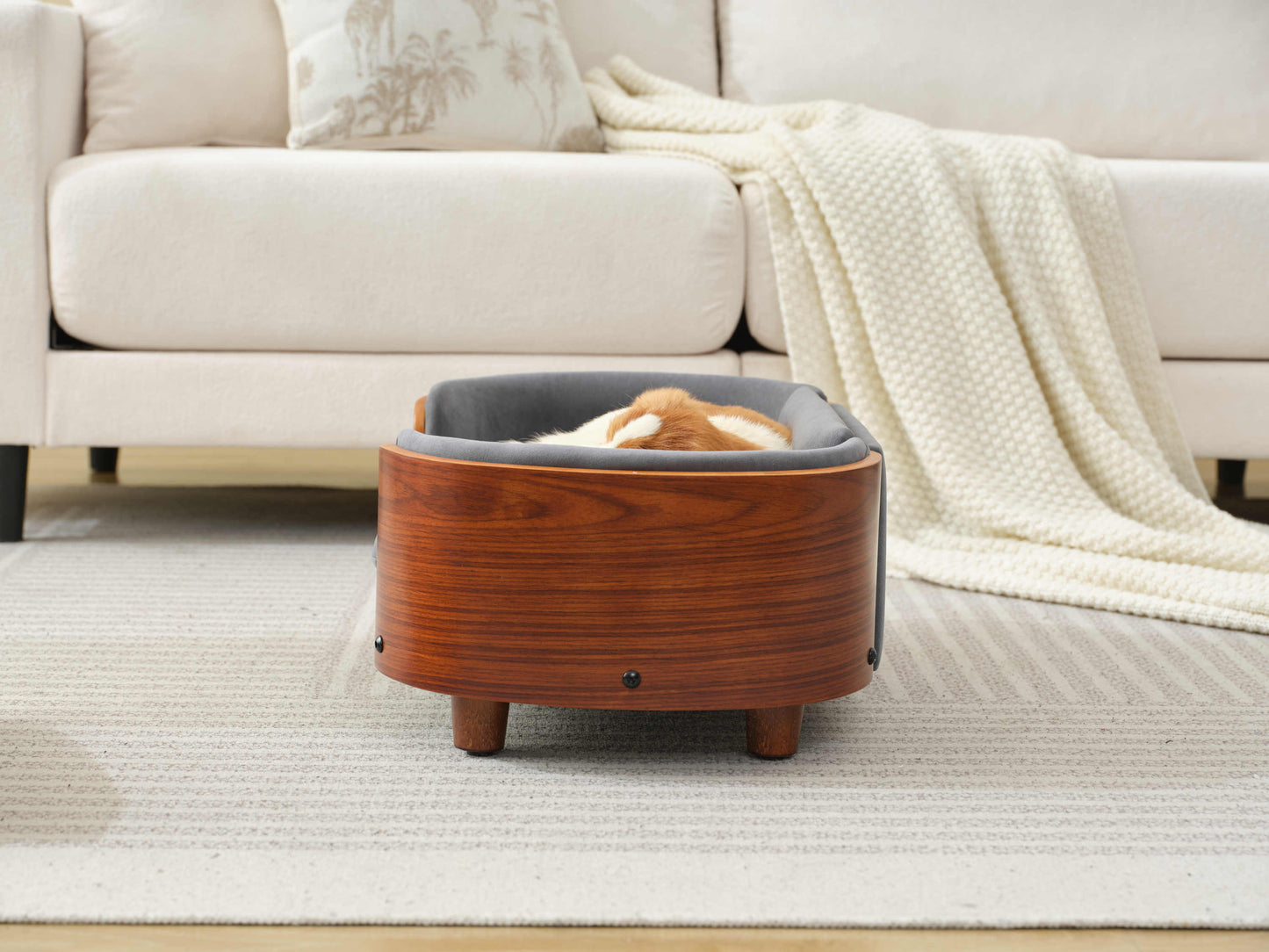 Rear view of Scandinavian Elevated Dog Bed featuring curved solid wood frame and elevated legs for airflow and support.