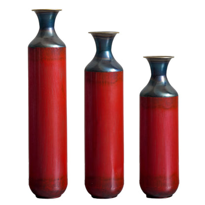 Droplet shaped metal floor vase set in red with glossy finish, ideal for modern home decor in living rooms or entryways.