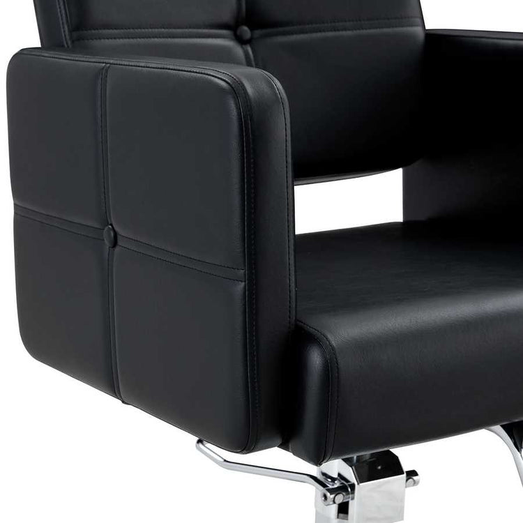 Close-up of black leather armrest with detailed stitching on salon chair