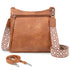 Brown leather handbag with patterned strap on a white background