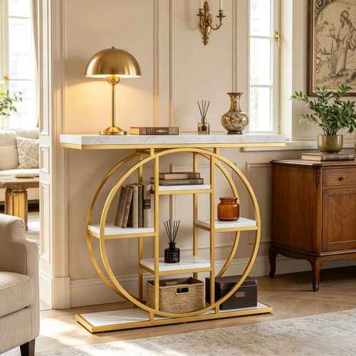 A modern gold console table with a circular open-frame design and white marble-look shelves, styled in a bright, elegant living room.