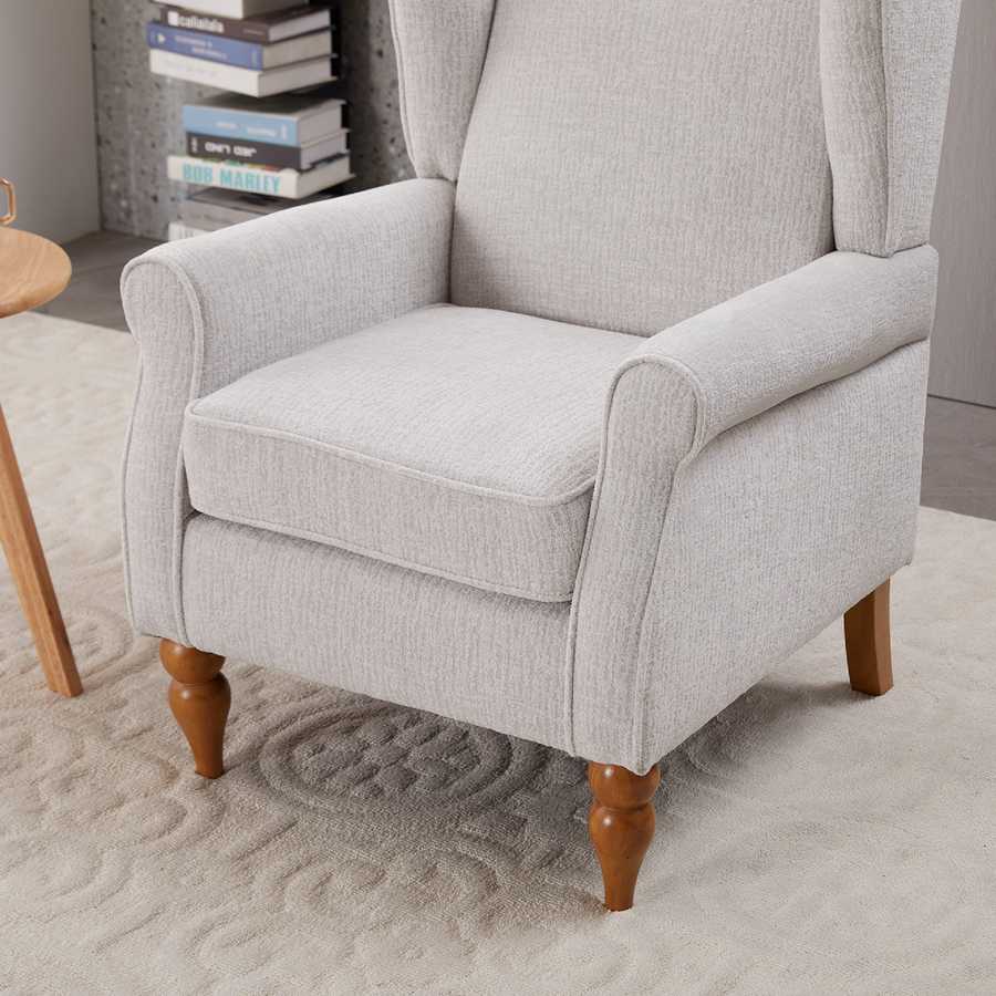Gray armchair with wooden legs in a room setting