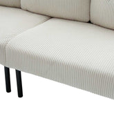 Close-up of a beige ribbed sofa with black legs on a white background