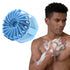 Man using a blue silicone scrubber on his arm with a white background