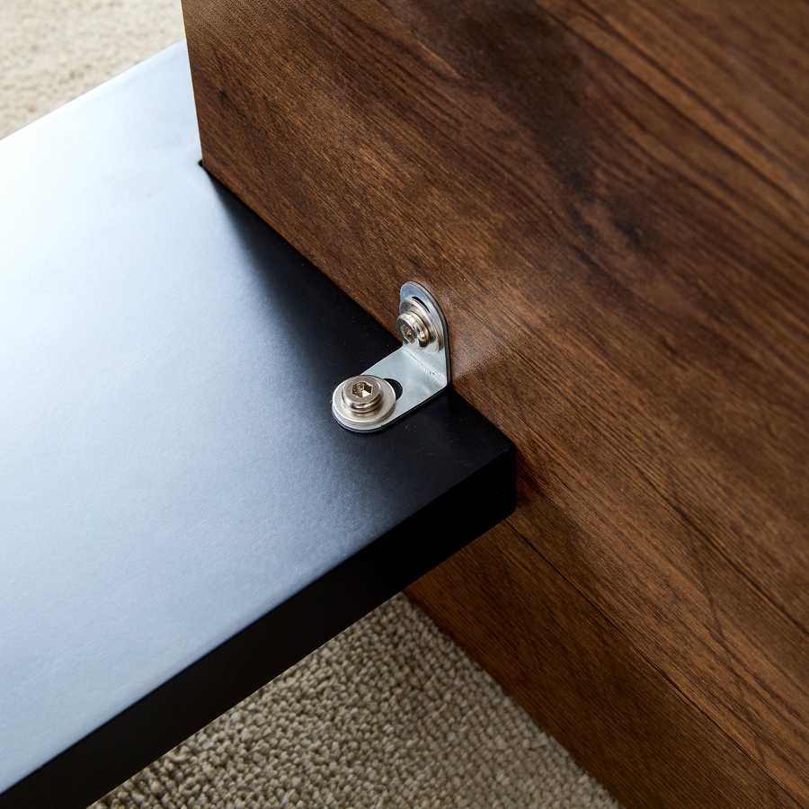 Underside view of Walnut MDF Coffee Table showing metal bracket attachment, emphasizing sturdy construction and quality craftsmanship.