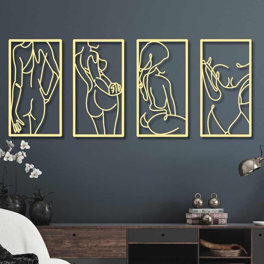 Four gold-framed abstract wall art pieces on a dark blue wall.