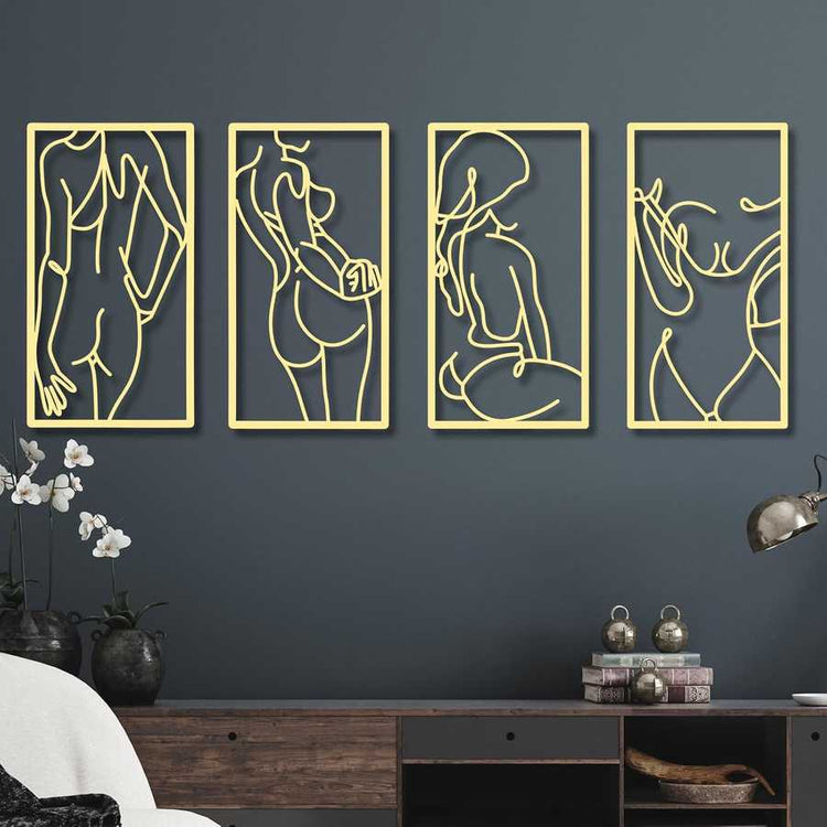Four gold-framed abstract wall art pieces on a dark blue wall.