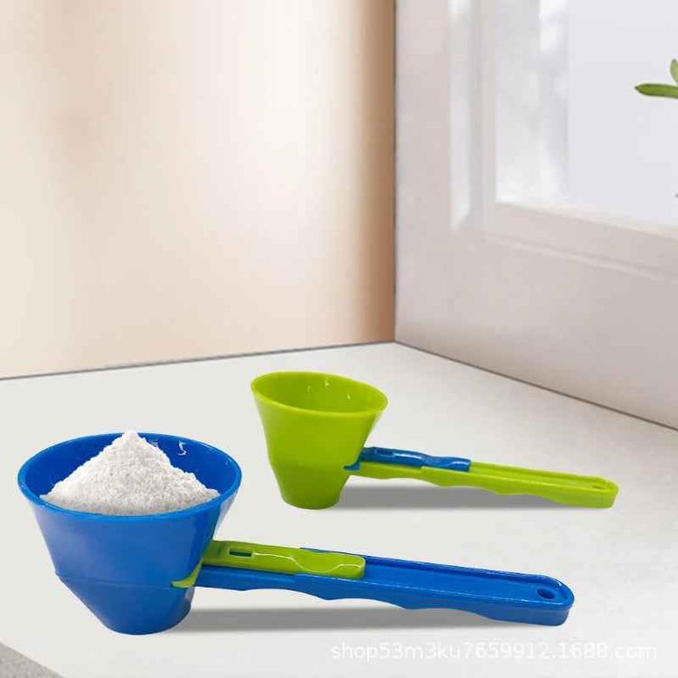 Blue and green measuring cups with a funnel on a white surface.