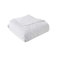 Folded white oversized quilted throw 60x70 made from soft cotton, perfect as a bed comforter for cozy and stylish home décor.