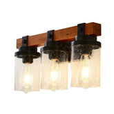 Three-light wall fixture with wooden bracket and glass shades on a white background