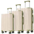Three-piece softside spinner luggage set in cream with sage green trim, including two handles and four wheels, shown on a white background.