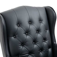 Black leather armchair with tufted backrest on a white background