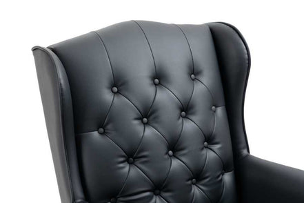 Black leather armchair with tufted backrest on a white background