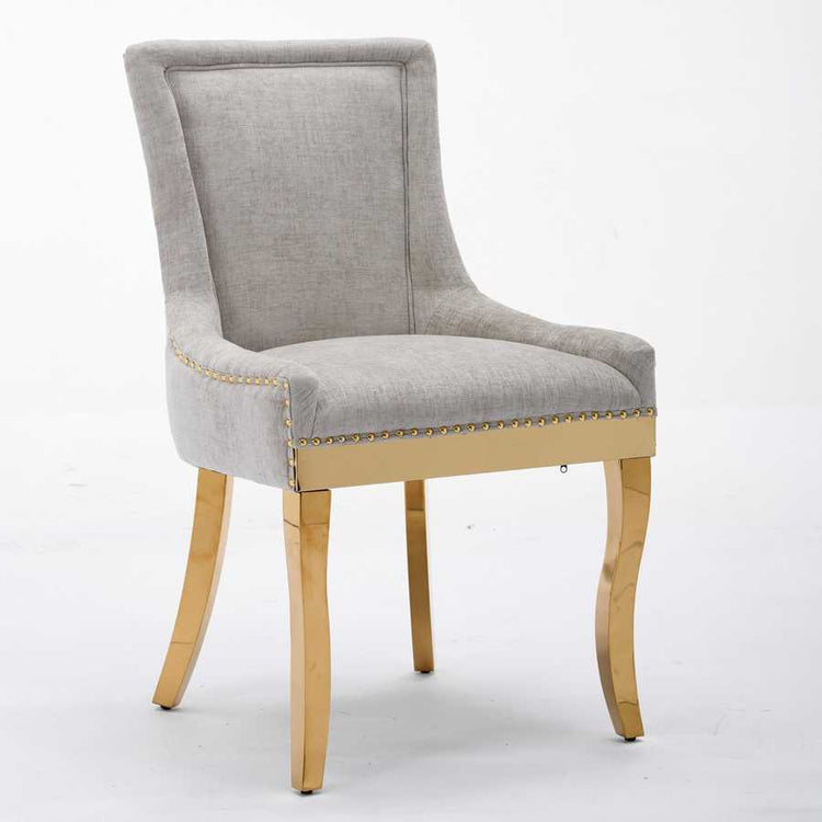 Gray upholstered chair with gold legs on a white background