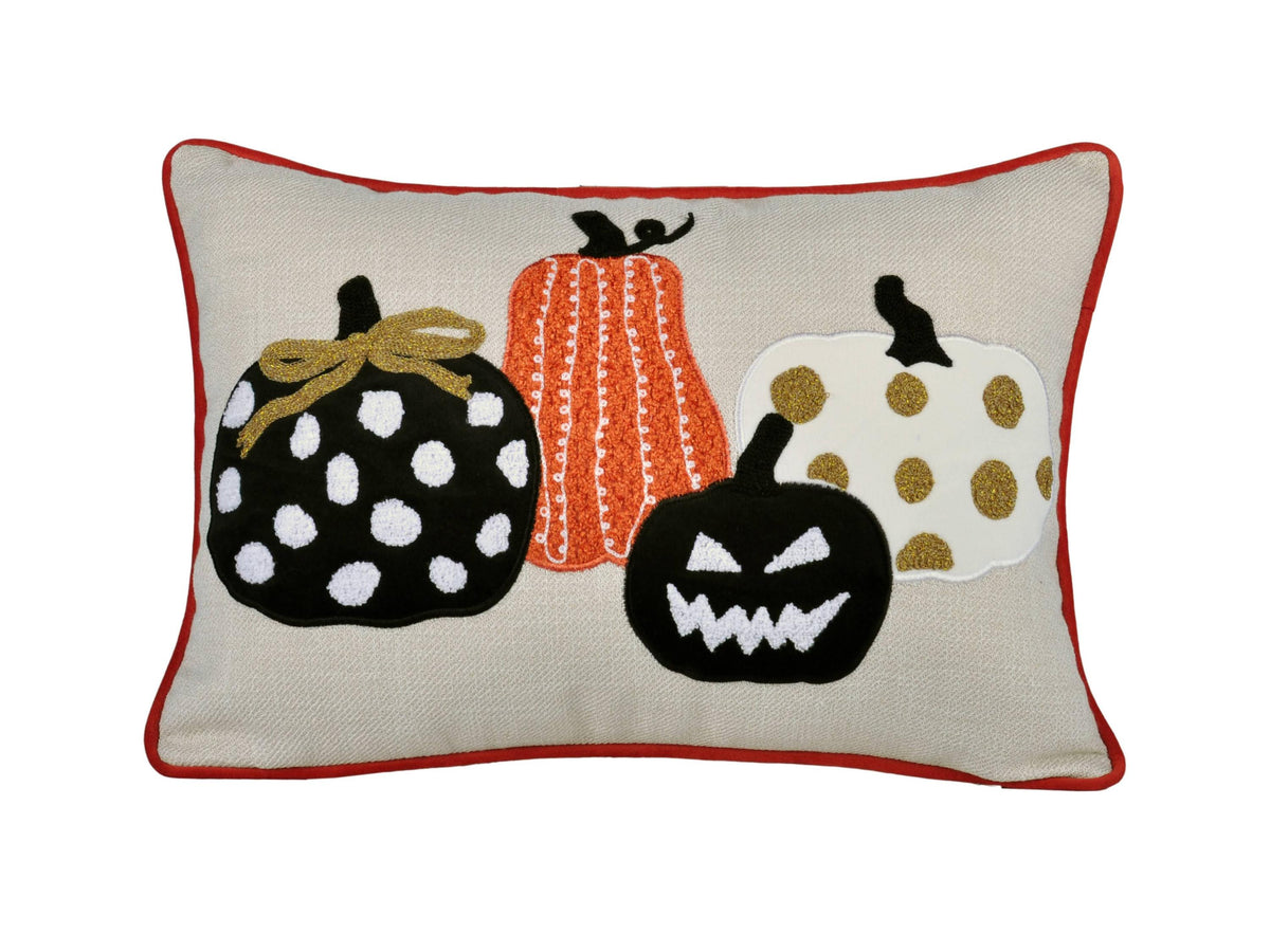 Decorative pillow with Halloween-themed pumpkins on a beige background
