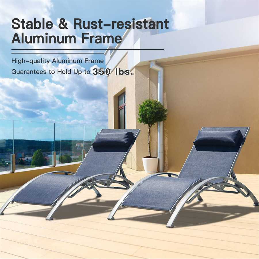 Two gray lounge chairs on a wooden deck with a building and sky in the background.