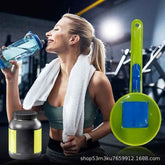 A woman in a gym setting drinks from a blue water bottle while wearing a white towel around her neck. A large green and blue cleaning brush is shown prominently on the right, and a black supplement tub with yellow labels appears at the bottom left.