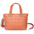 Quilted orange handbag with a colorful strap on a white background