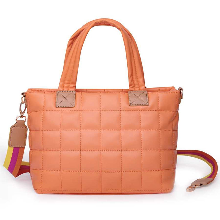 Quilted orange handbag with a colorful strap on a white background