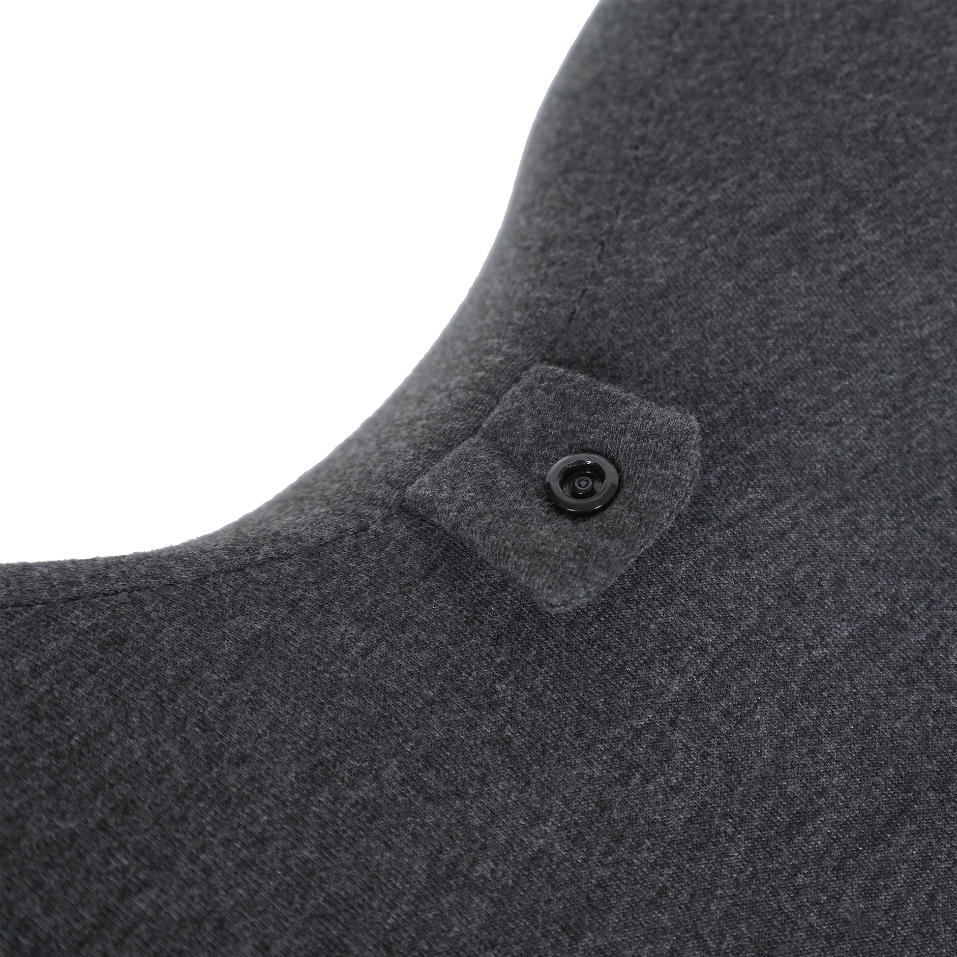 Close-up of button attachment on Ergonomic Memory Foam Bed Pillow for Spinal Support, highlighting adjustable headrest feature for added support.