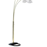 Arc floor lamp with gold base and crystal-like top on a white background