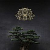 Gold Iron Mandala Lotus Wall Art on a dark wall above a bonsai tree. Complements tranquil, nature-inspired zen decor themes.