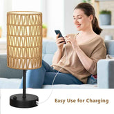 Woman sitting on a couch using a smartphone with a lamp next to her, indicating easy use for charging.