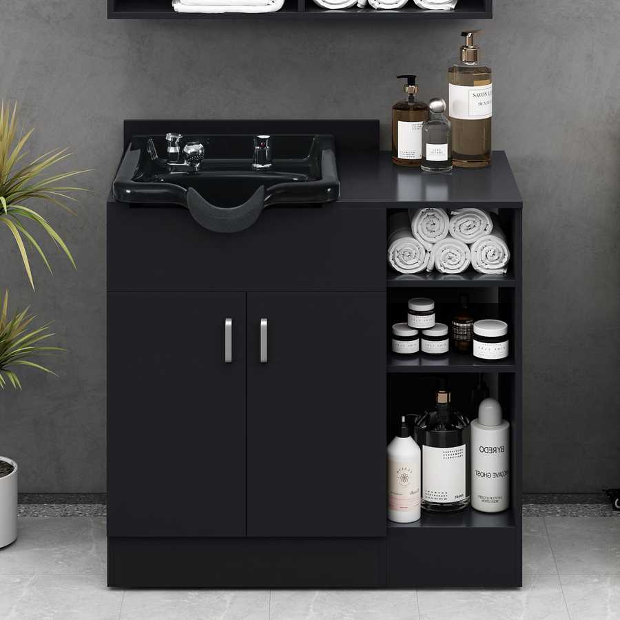 Black bathroom vanity with sink and toiletries against a gray wall.