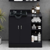 Black bathroom vanity with sink and toiletries against a gray wall.