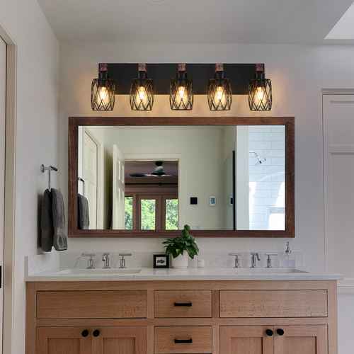 Bathroom vanity with large mirror, lights above, and decorative elements.