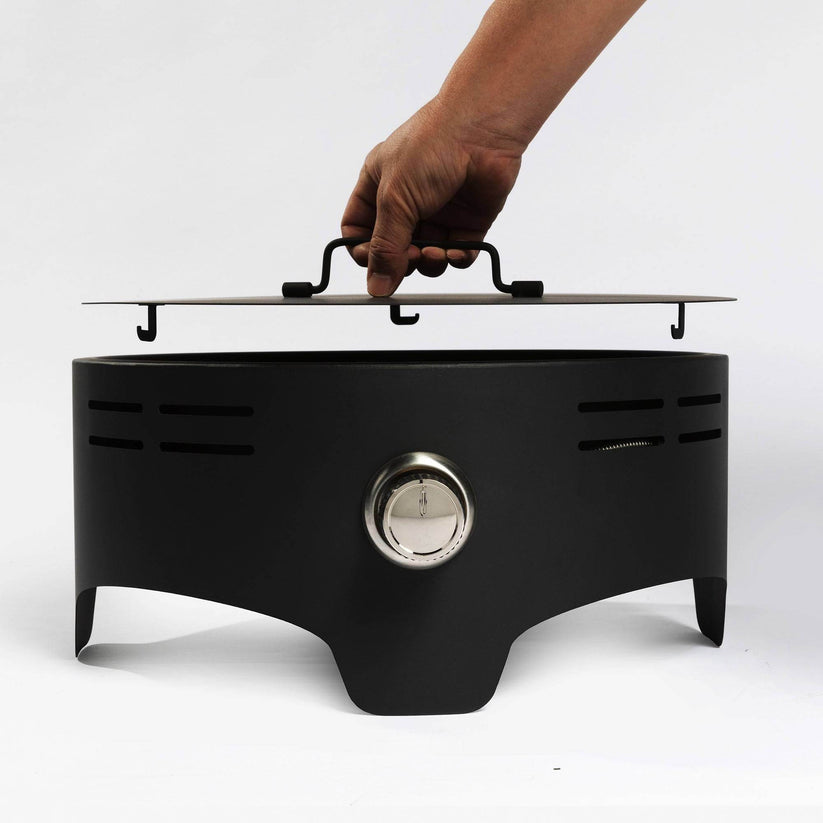 Durable tabletop fire pit lid being removed
