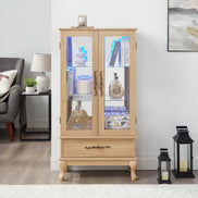 Lighted curio cabinet with adjustable glass shelves and drawer, showcasing collectibles in a modern living room setting.