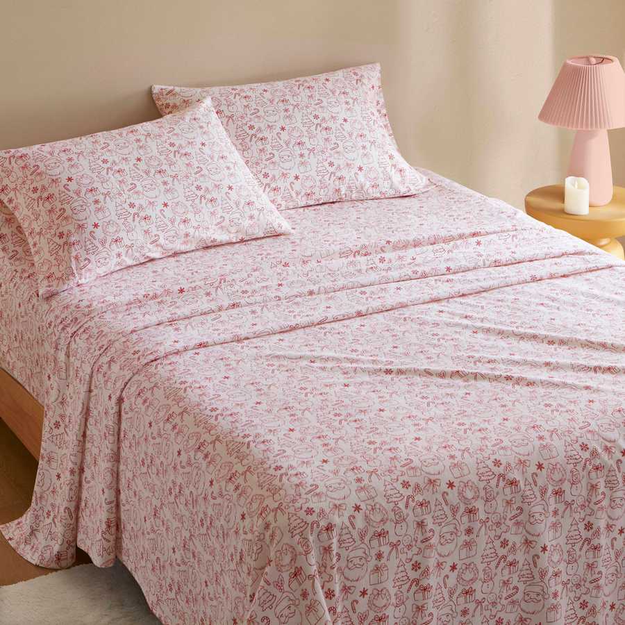Holiday Doodles Twin XL Cotton Flannel Sheet Set styled on a bed, offering seasonal charm and comfort for dorm or guest rooms.