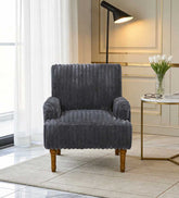 Gray armchair in a stylish living room with a lamp and table.