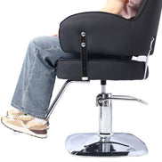 Person seated in Heavy Duty Salon Chair with wide black seat and chrome footrest, demonstrating ergonomic salon use.