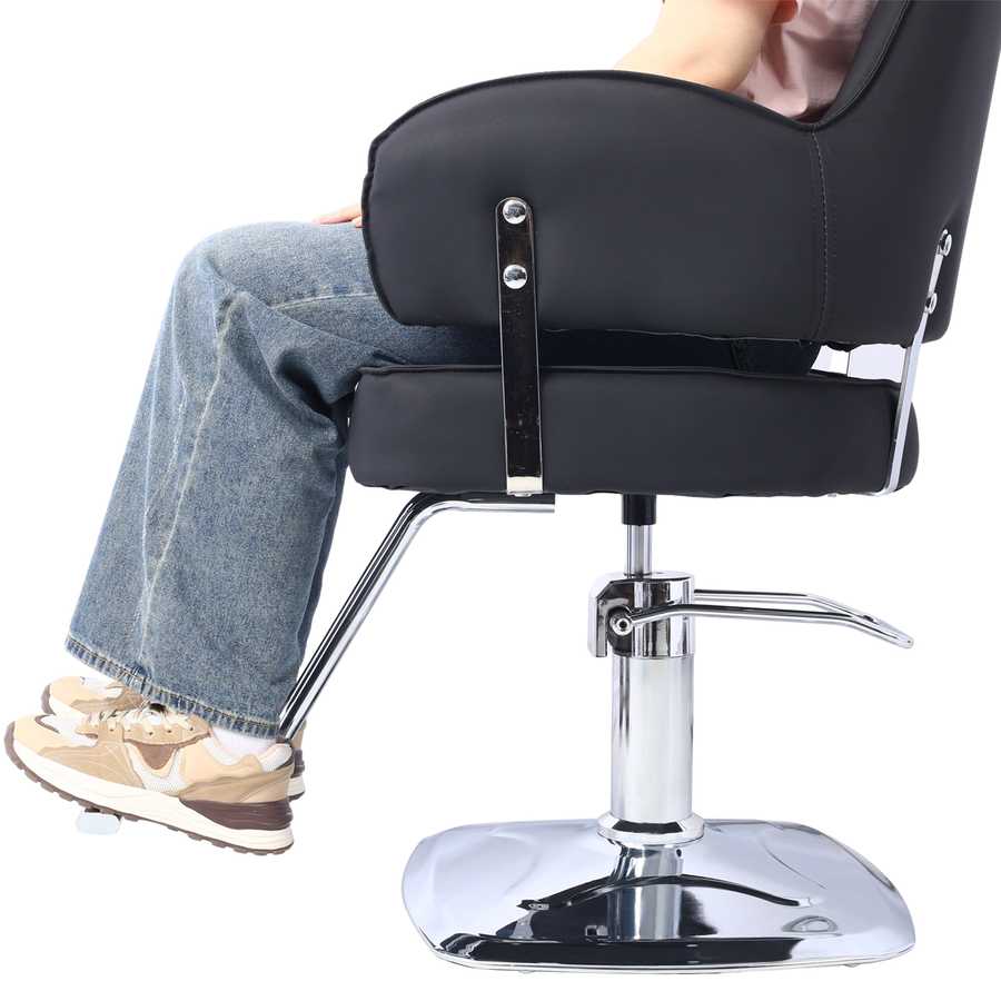 Person seated in Heavy Duty Salon Chair with wide black seat and chrome footrest, demonstrating ergonomic salon use.