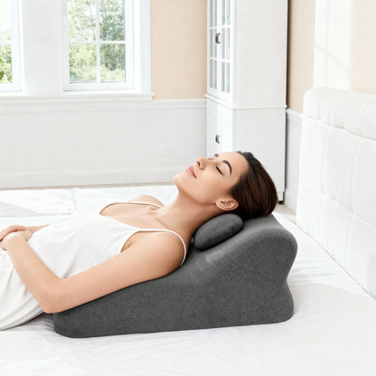 Woman reclining on Ergonomic Memory Foam Bed Pillow - Spinal Support Pillow, demonstrating neck and back support for relaxation in bed.