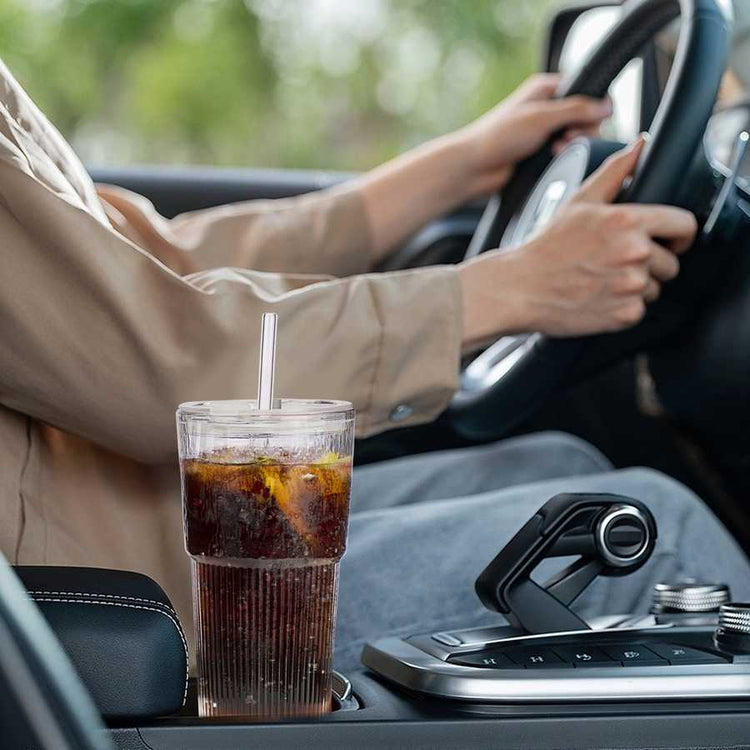 Cold drink with straw in car cup holder